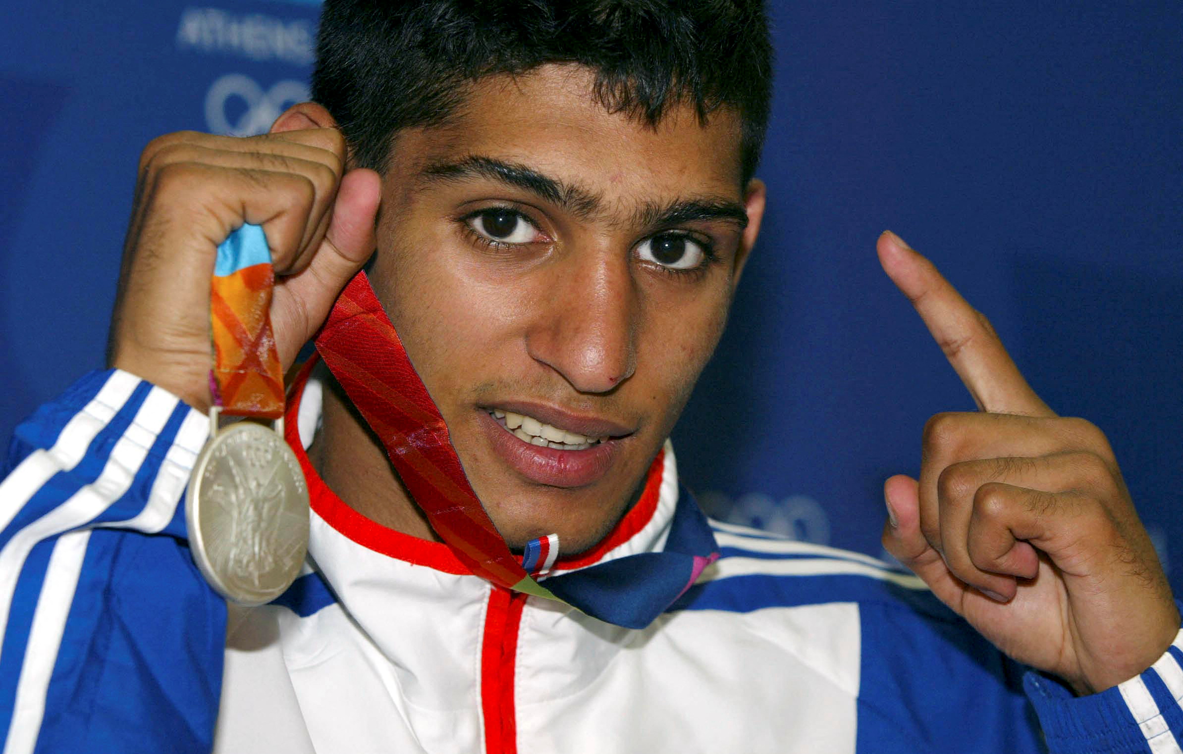 FILE PHOTO: Boxing - Olympics - Athens 2004 Olympic Games - Athens - 29/8/04 Amir Khan with the Olympic Silver Medal he won for Britain today Action Images via Reuters/Richard Heathcote/File Photo