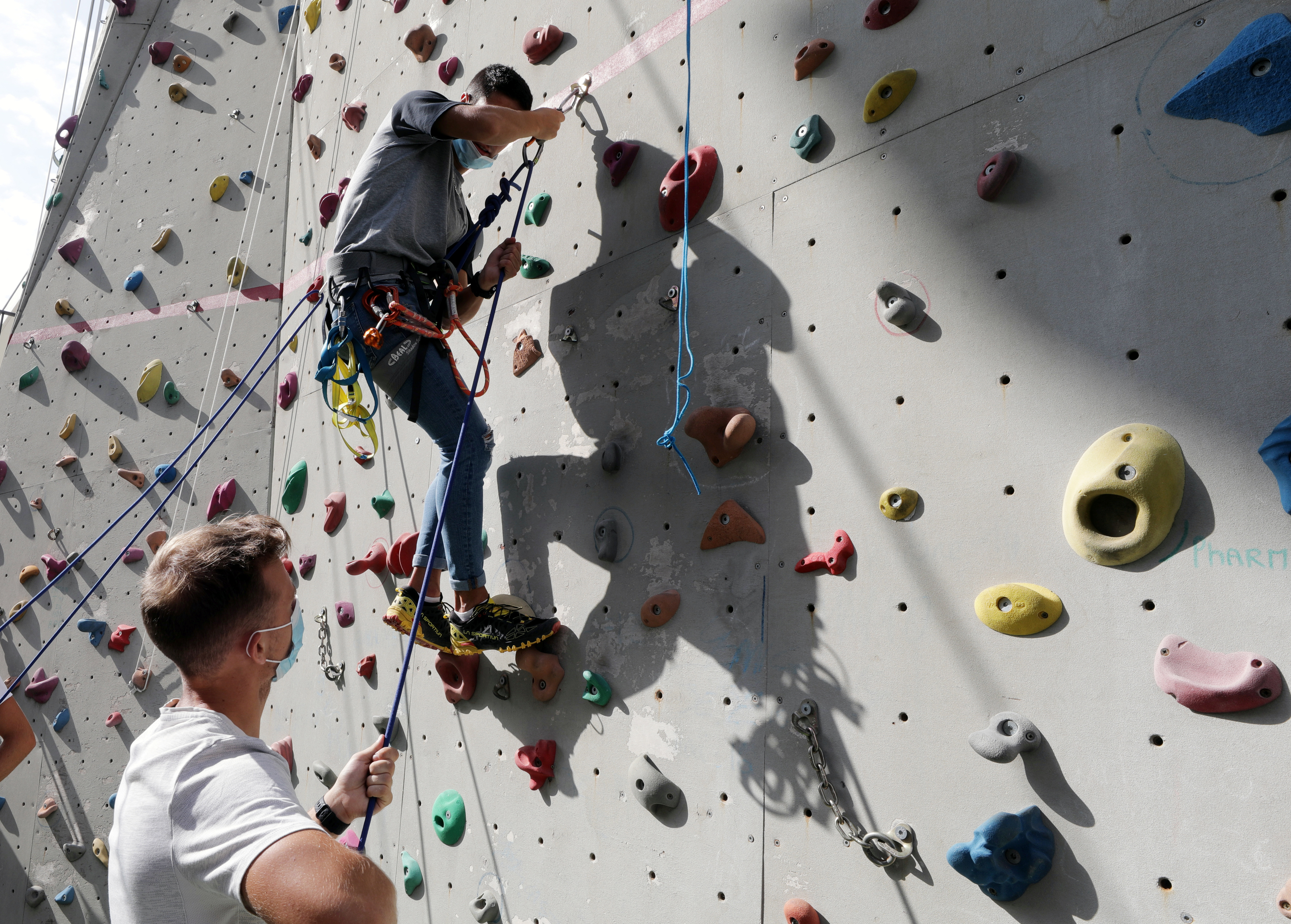 Students of the faculty of sport sciences at Universite Cote d'Azur wearing protective masks to avoid the spread of the coronavirus disease (COVID-19), practice sport climbing, as French universities struggle to contain outbreaks at the beginning of the school year in Nice, France, September 24, 2020. Picture taken September 24, 2020. REUTERS/Eric Gaillard